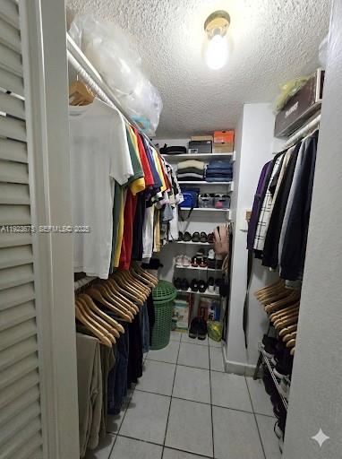 1939 Southwest 5th Street, Unit 4 Miami, FL 33135 - Photo 8 of 13 a view of walk in closet with clothes and shoes