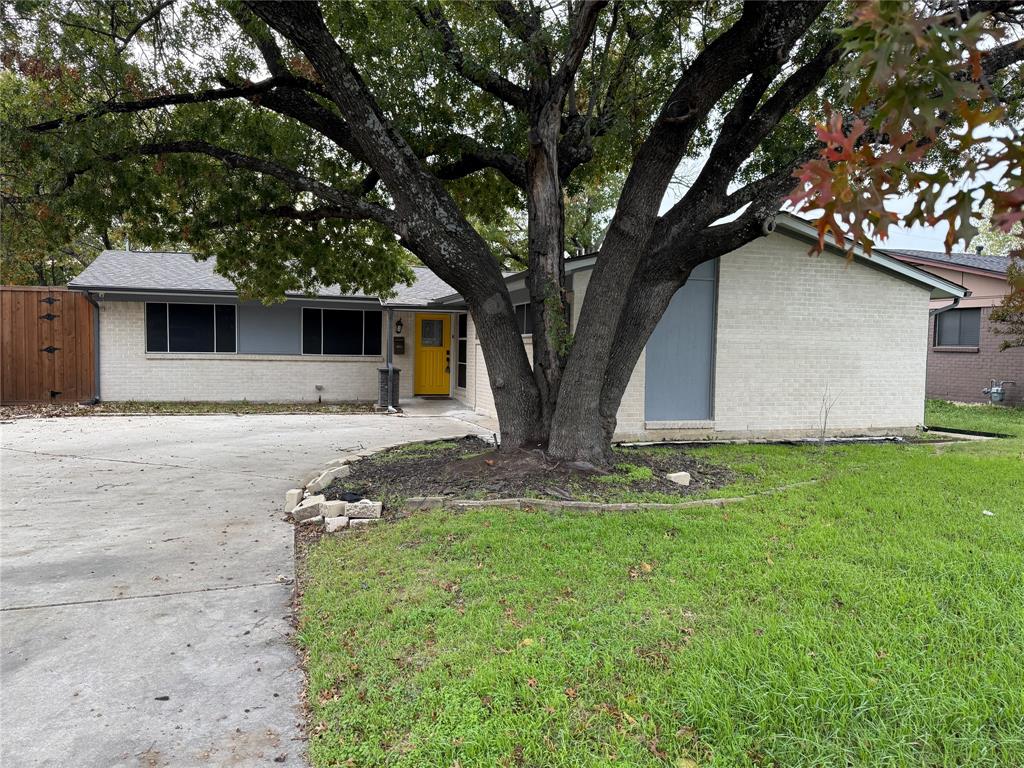 2847 West Rochelle Road Irving, TX 75062 - Photo 1 of 1 View of front facade featuring a front lawn, brick siding, driveway, a gate, and a shingled roof