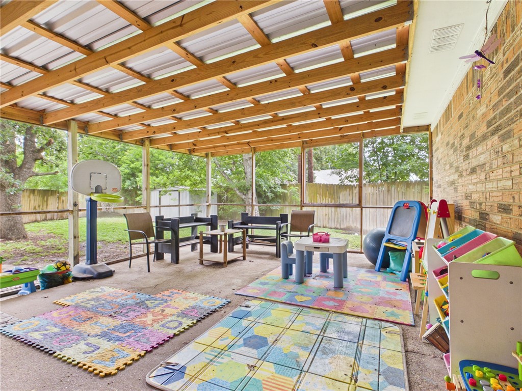 800 Rio Grande Lane Bryan, TX 77801 - Photo 18 of 23 a living room with patio furniture and a floor to ceiling window