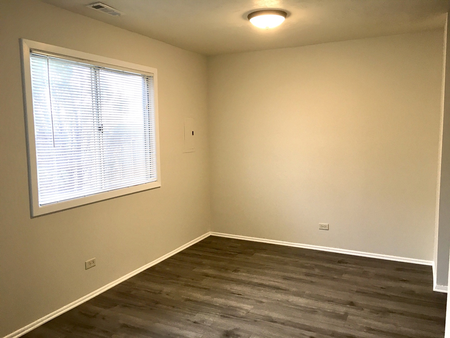 Undisclosed Address Carol Stream, IL 60188 - Photo 3 of 9 a view of an empty room with wooden floor and a window