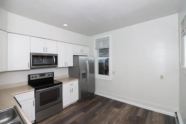 a kitchen with stainless steel appliances a refrigerator stove and microwave