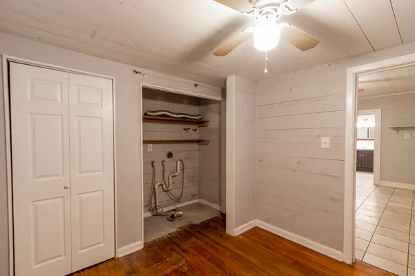 a view of a room with wooden floor and closet area