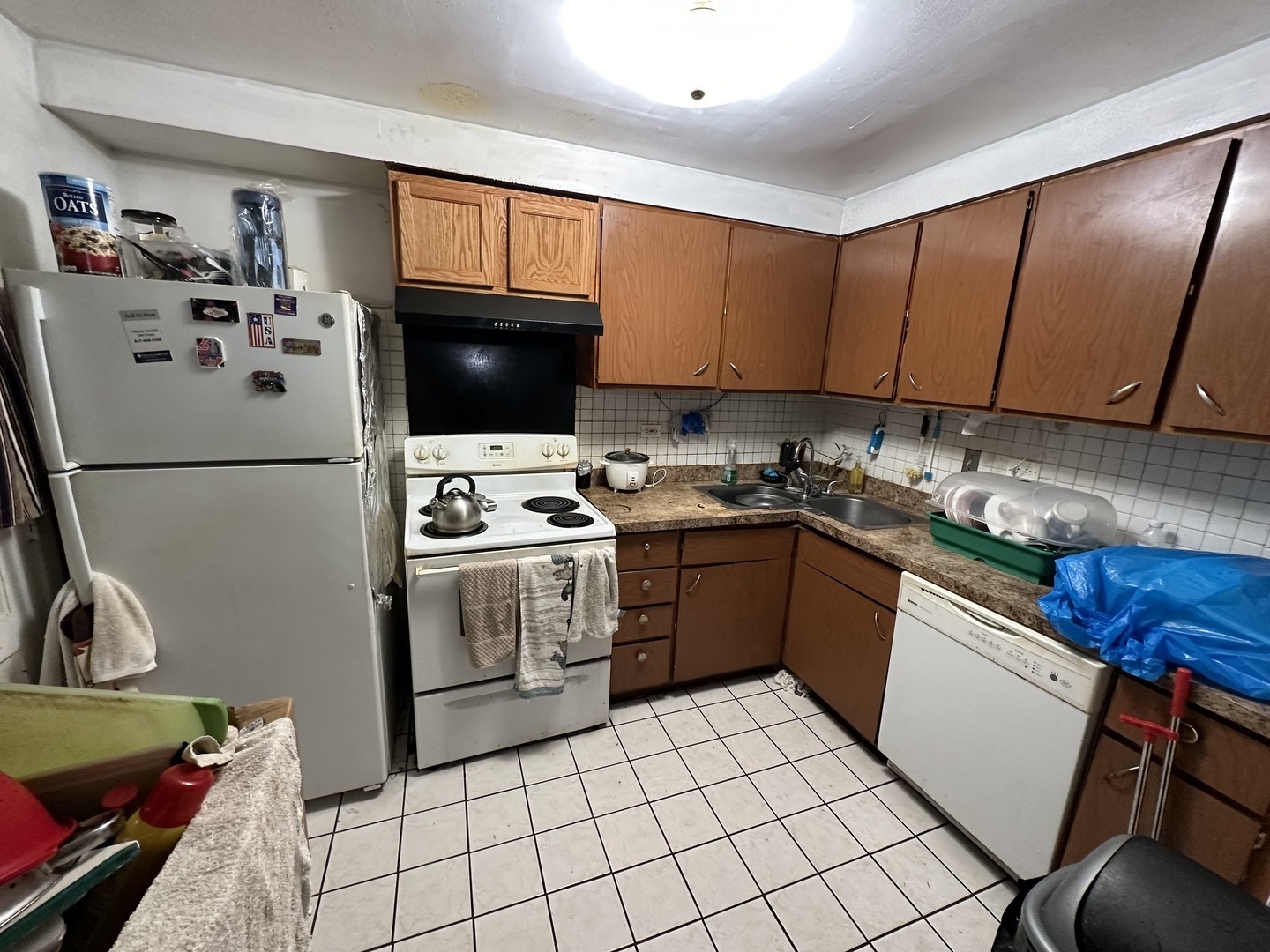 8820 Robin Drive Des Plaines, IL 60016 - Photo 4 of 10 a kitchen with a refrigerator a stove a sink and cabinets