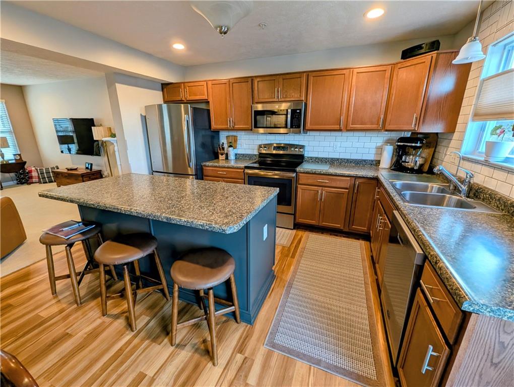 146 Rylie Drive Harmony, PA 16037 - Photo 14 of 43 a kitchen with granite countertop a stove a sink a dining table and chairs