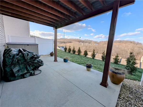 a view of a patio with lawn chairs and a floor to ceiling window