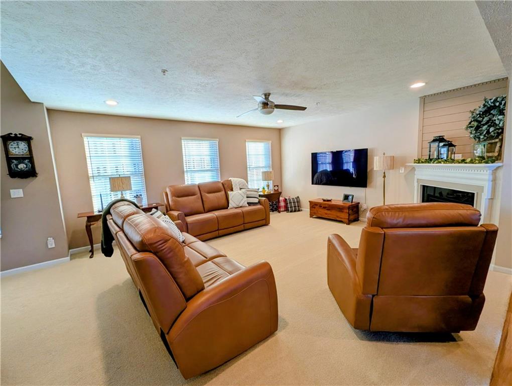 146 Rylie Drive Harmony, PA 16037 - Photo 9 of 43 a living room with furniture a fireplace and a flat screen tv