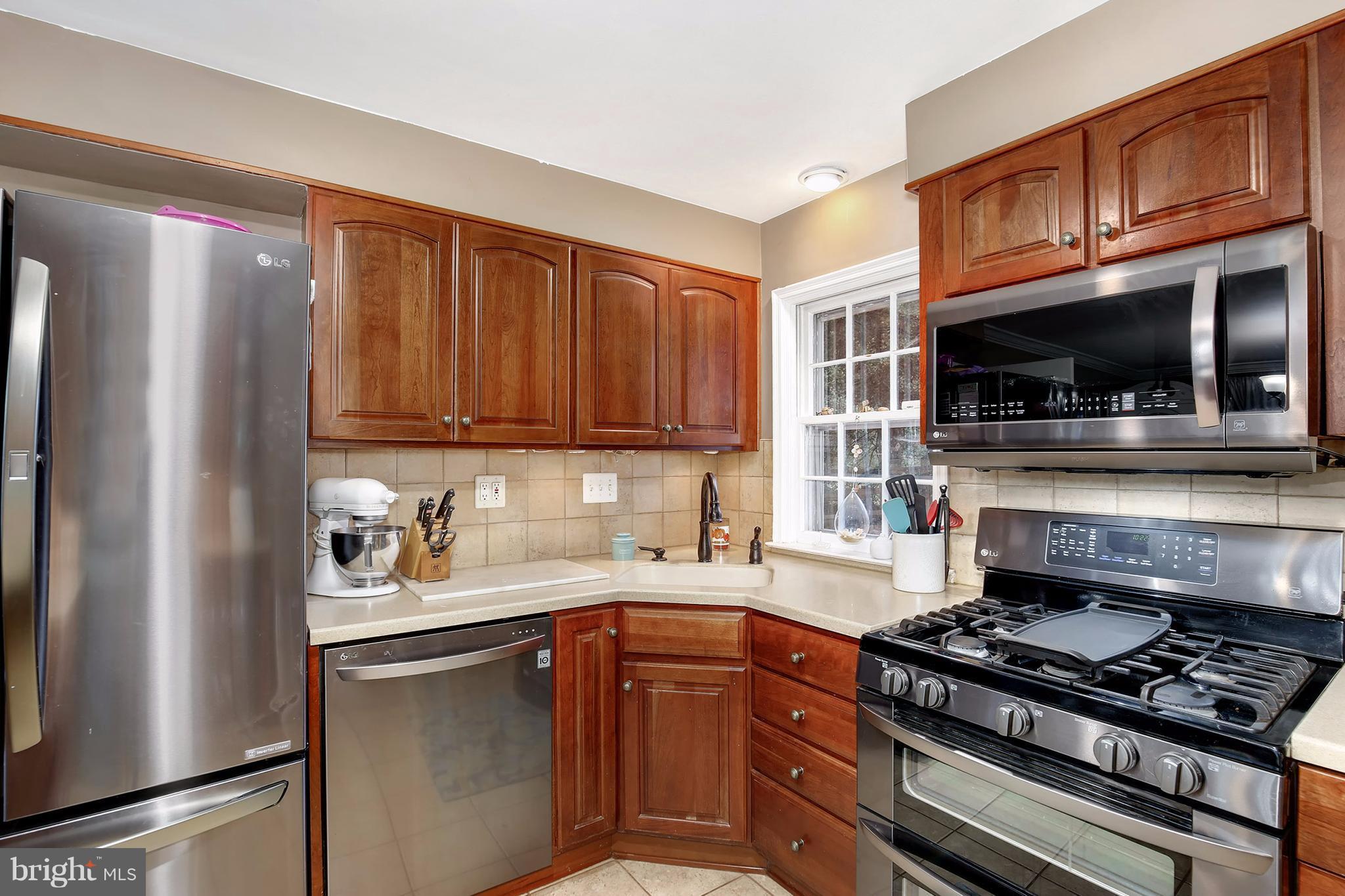 603 Carysbrook Road Baltimore, MD 21208 - Photo 11 of 30 a kitchen with stainless steel appliances a stove a sink and a refrigerator
