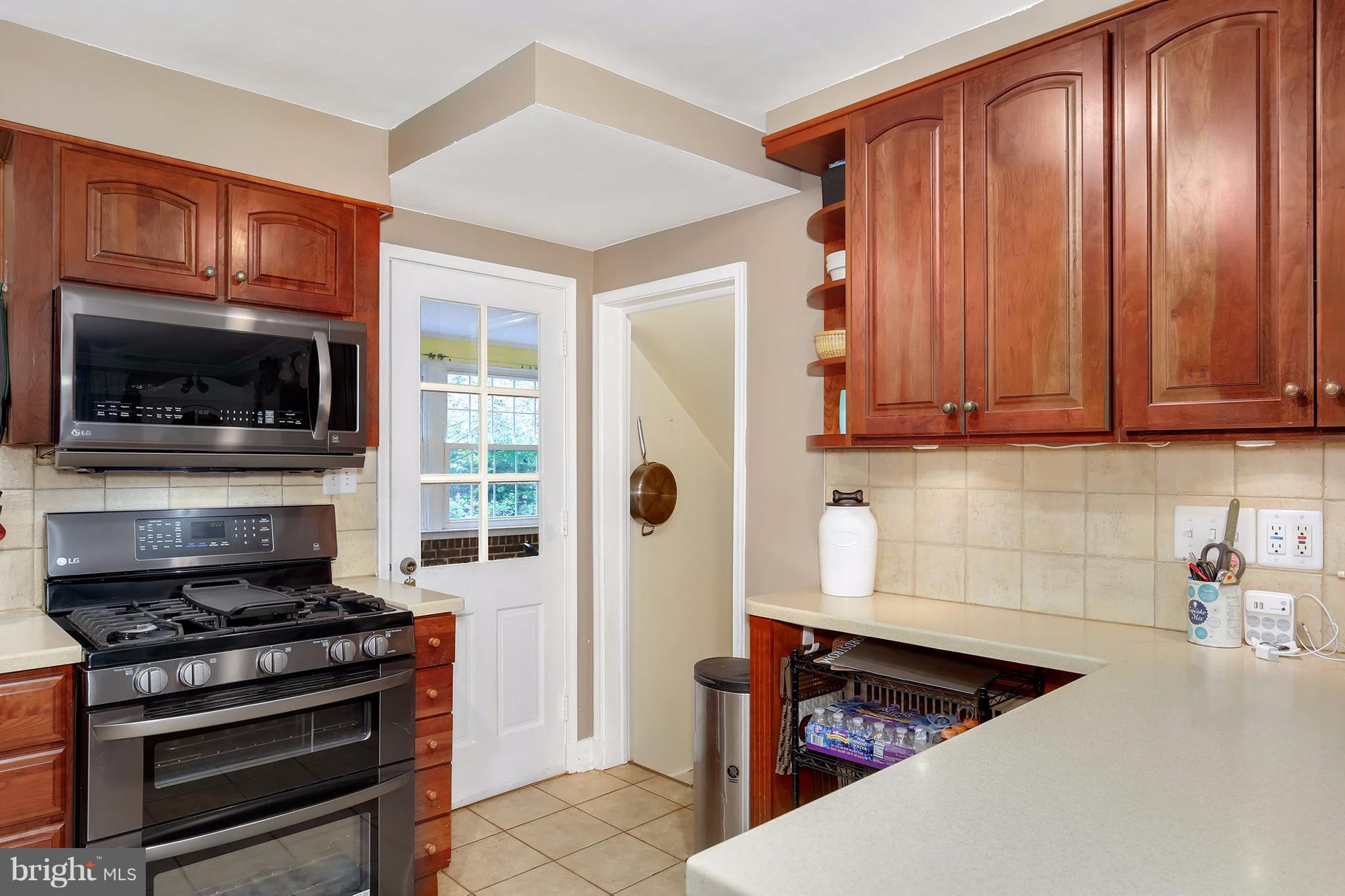 603 Carysbrook Road Baltimore, MD 21208 - Photo 12 of 30 a kitchen with wooden cabinets and a stove top oven