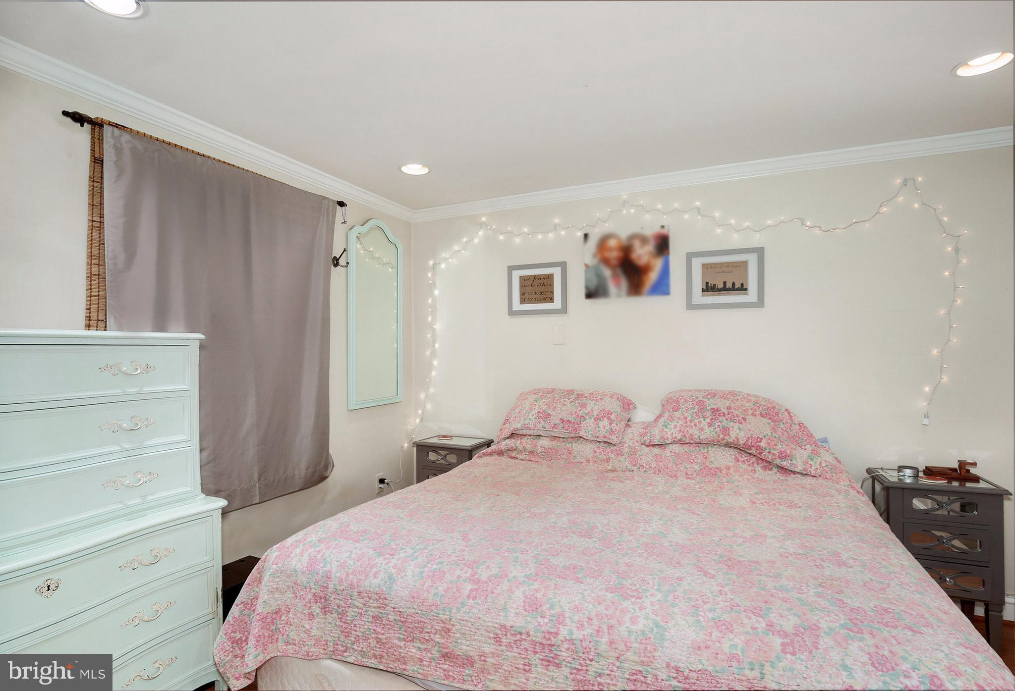 603 Carysbrook Road Baltimore, MD 21208 - Photo 15 of 30 a bedroom with a bed and a cabinets