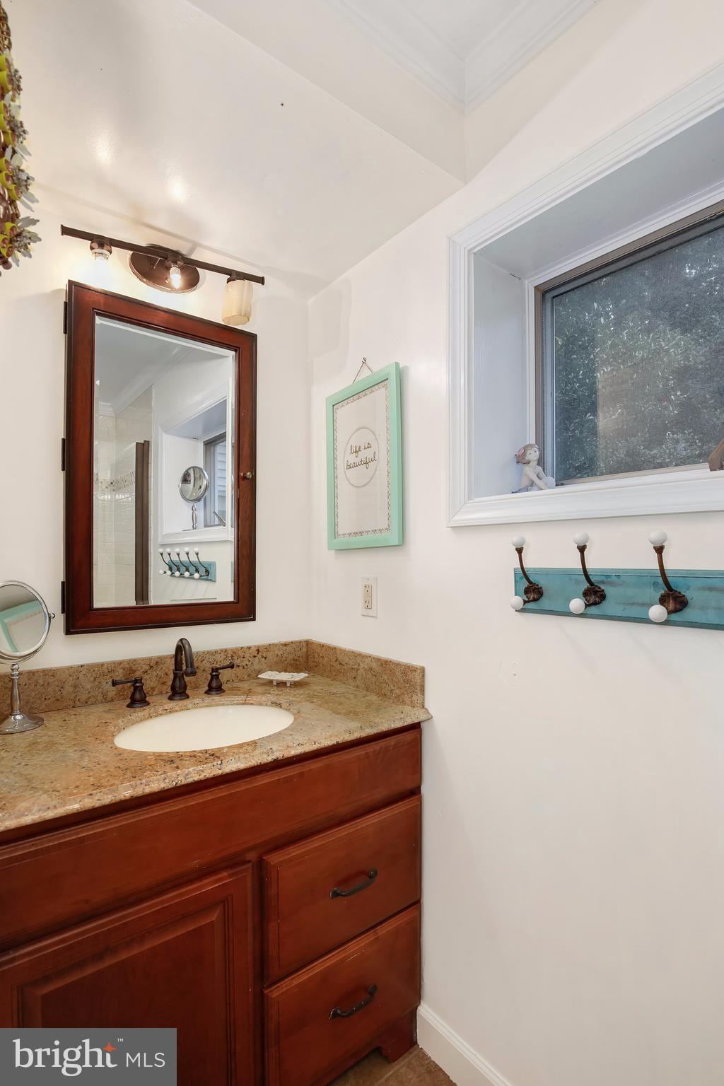 603 Carysbrook Road Baltimore, MD 21208 - Photo 17 of 30 a bathroom with a granite countertop sink mirror and vanity