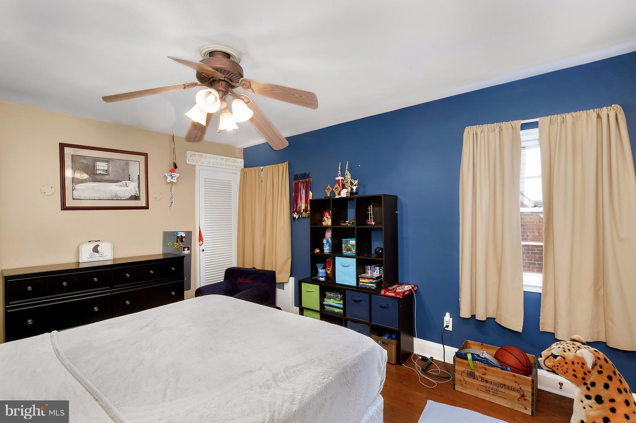 603 Carysbrook Road Baltimore, MD 21208 - Photo 19 of 30 a bedroom with a bed cabinets and window