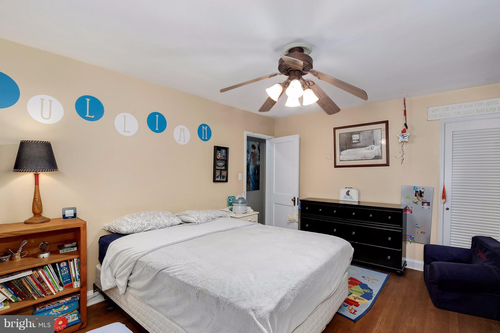 603 Carysbrook Road Baltimore, MD 21208 - Photo 20 of 30 a bedroom with a bed and a chandelier