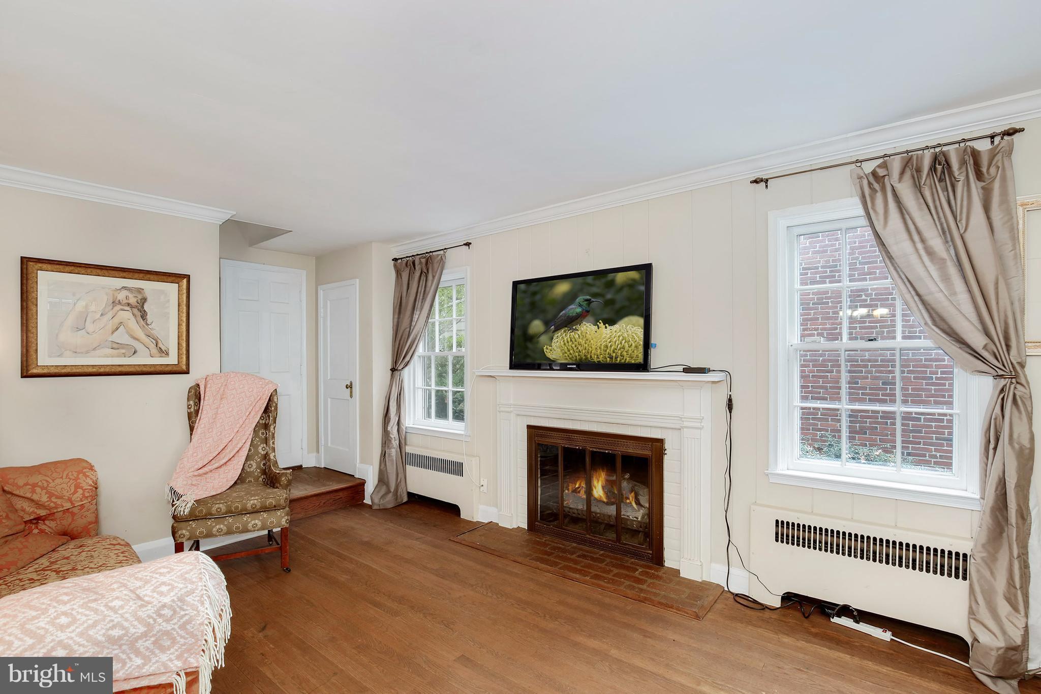 603 Carysbrook Road Baltimore, MD 21208 - Photo 3 of 30 a living room with furniture a flat screen tv and a fireplace