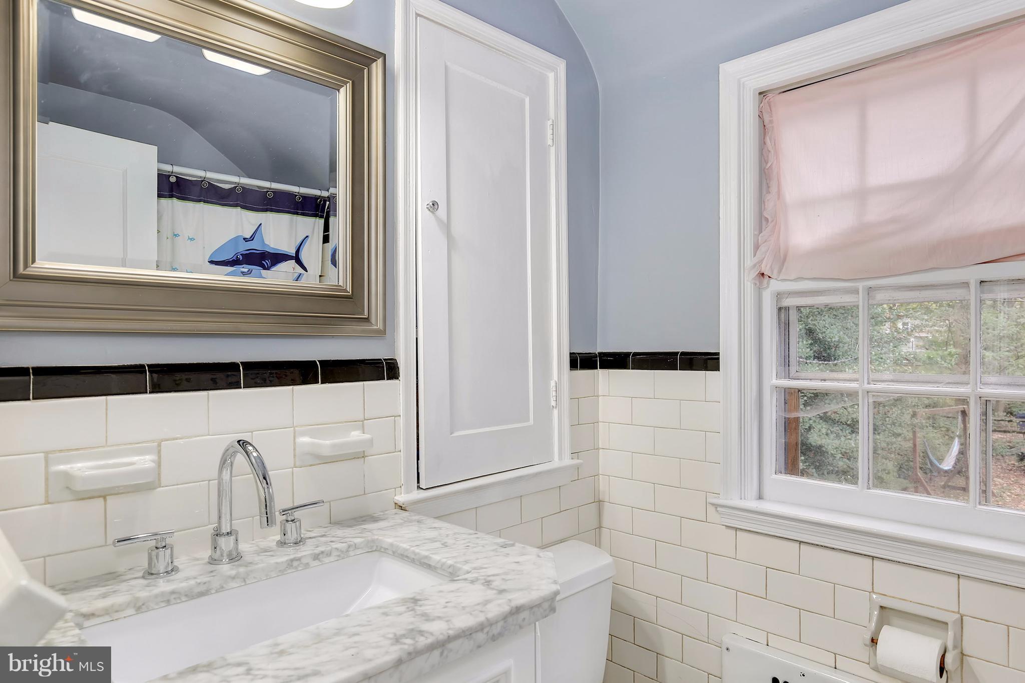 603 Carysbrook Road Baltimore, MD 21208 - Photo 23 of 30 a bathroom with a granite countertop sink and a mirror