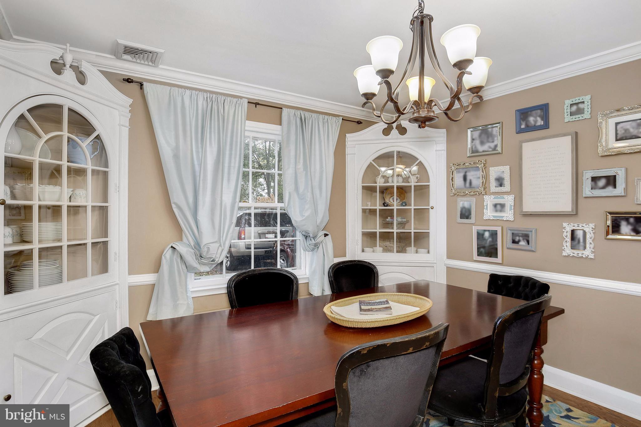 603 Carysbrook Road Baltimore, MD 21208 - Photo 8 of 30 a view of a dining room with furniture a chandelier and wooden floor