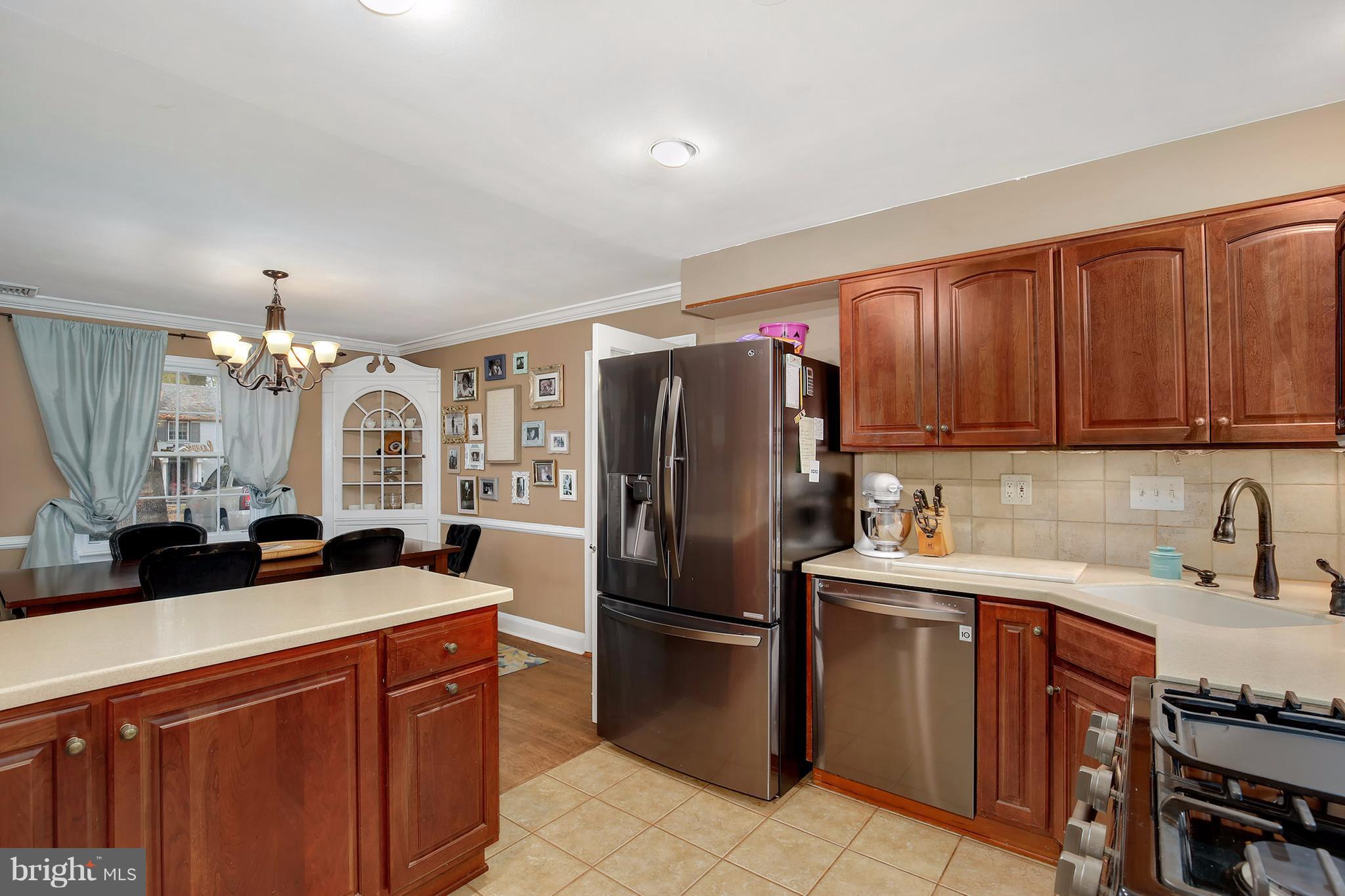 603 Carysbrook Road Baltimore, MD 21208 - Photo 9 of 30 a kitchen with stainless steel appliances a sink cabinets and a refrigerator
