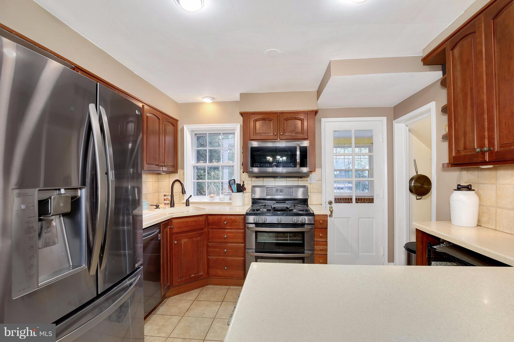 603 Carysbrook Road Baltimore, MD 21208 - Photo 10 of 30 a kitchen with stainless steel appliances a refrigerator and a stove top oven