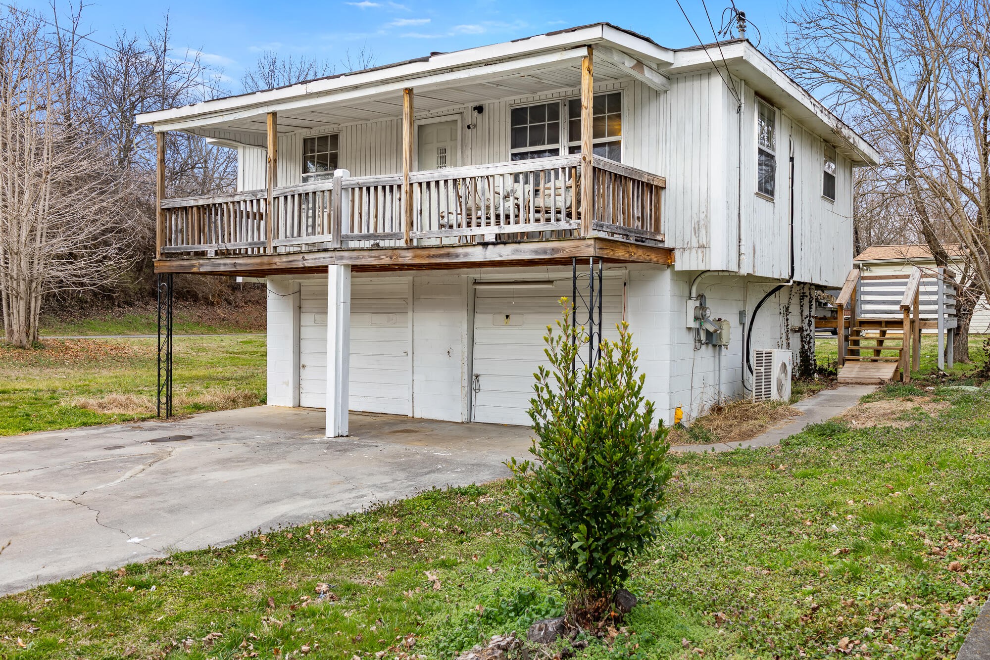 527 North Kilgore Street Athens, TN 37303 - Photo 2 of 13 a front view of a house with a garden and garage