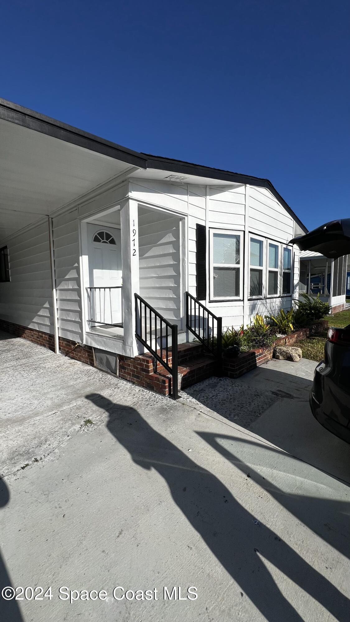 1972 Big Cypress Street Northeast Palm Bay, FL 32905 - Photo 2 of 7 a front view of a house with yard