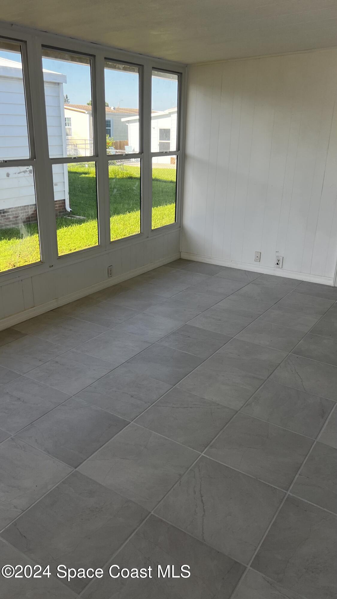 1972 Big Cypress Street Northeast Palm Bay, FL 32905 - Photo 5 of 7 a view of an empty room with a window