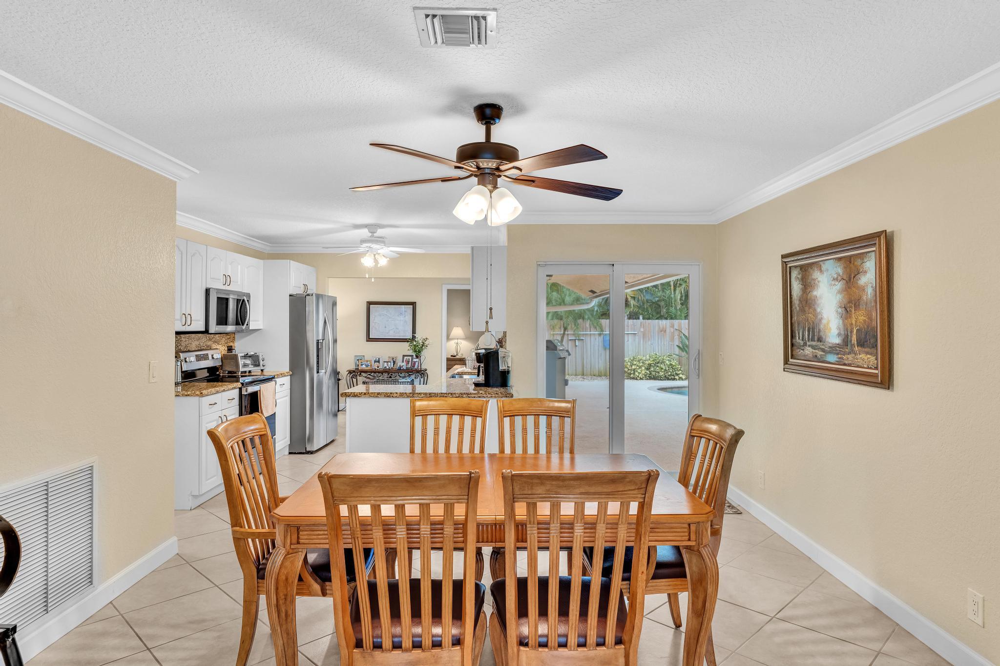 3106 Cormorant Road Delray Beach, FL 33444 - Photo 11 of 45 a view of a dining room with furniture window and wooden floor