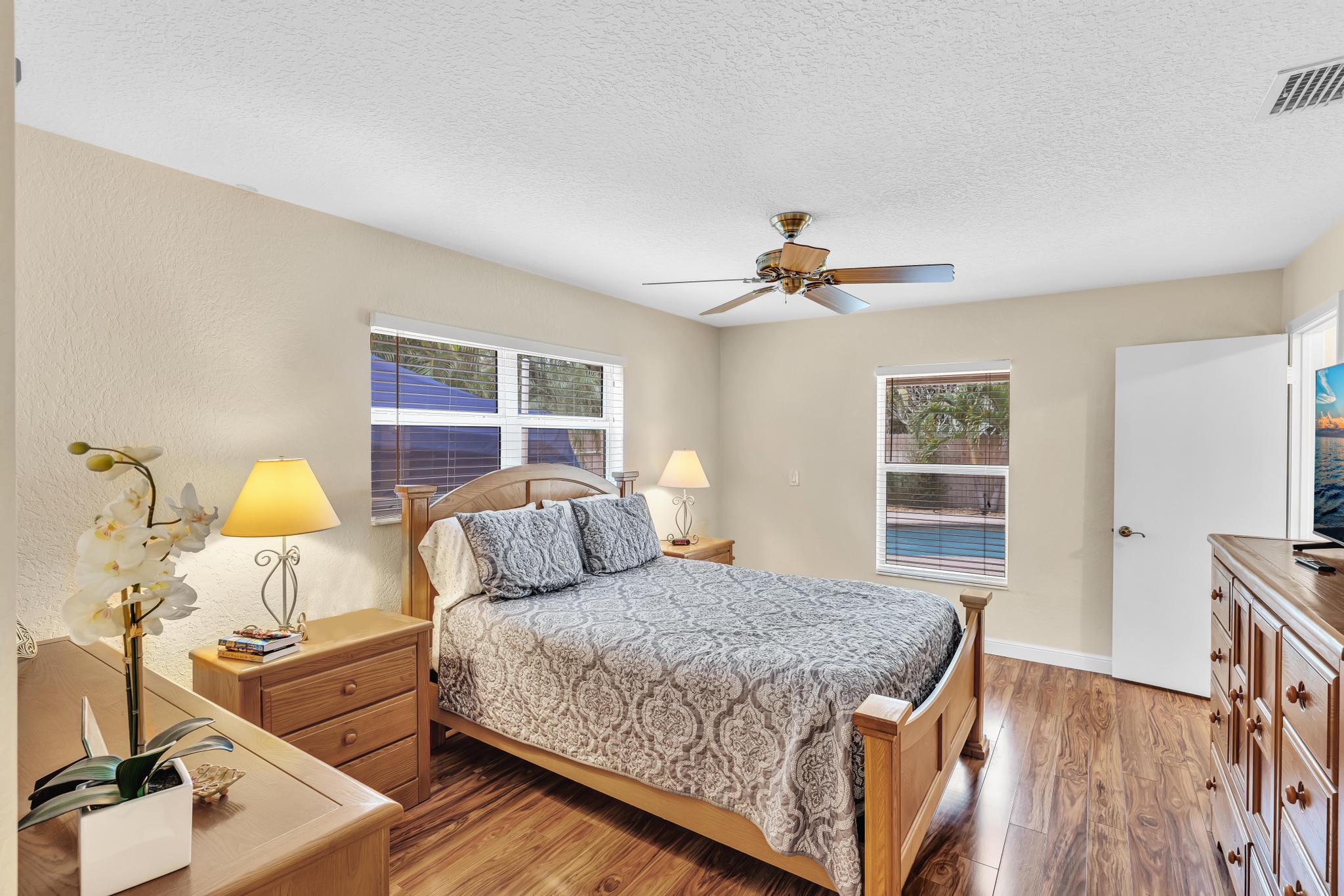3106 Cormorant Road Delray Beach, FL 33444 - Photo 16 of 45 a bedroom with a bed and wooden floor