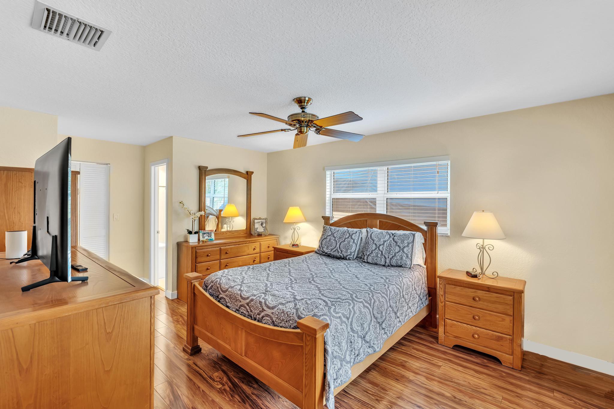 3106 Cormorant Road Delray Beach, FL 33444 - Photo 17 of 45 a bedroom with a bed and wooden floor