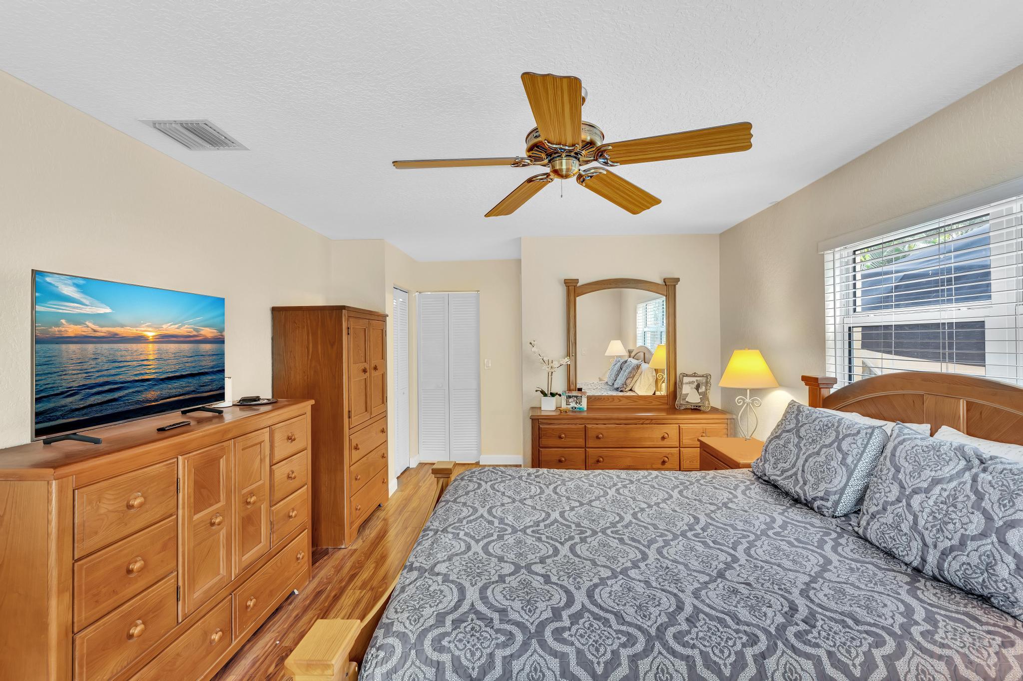3106 Cormorant Road Delray Beach, FL 33444 - Photo 18 of 45 a bedroom with furniture and flat screen tv