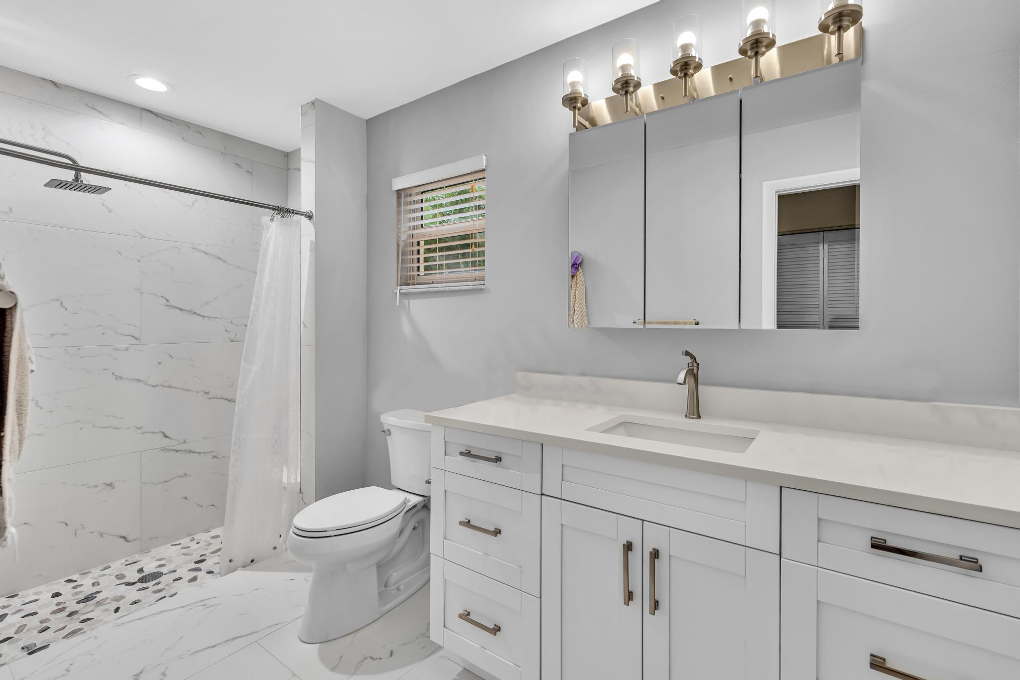 3106 Cormorant Road Delray Beach, FL 33444 - Photo 19 of 45 a bathroom with a sink a toilet and shower