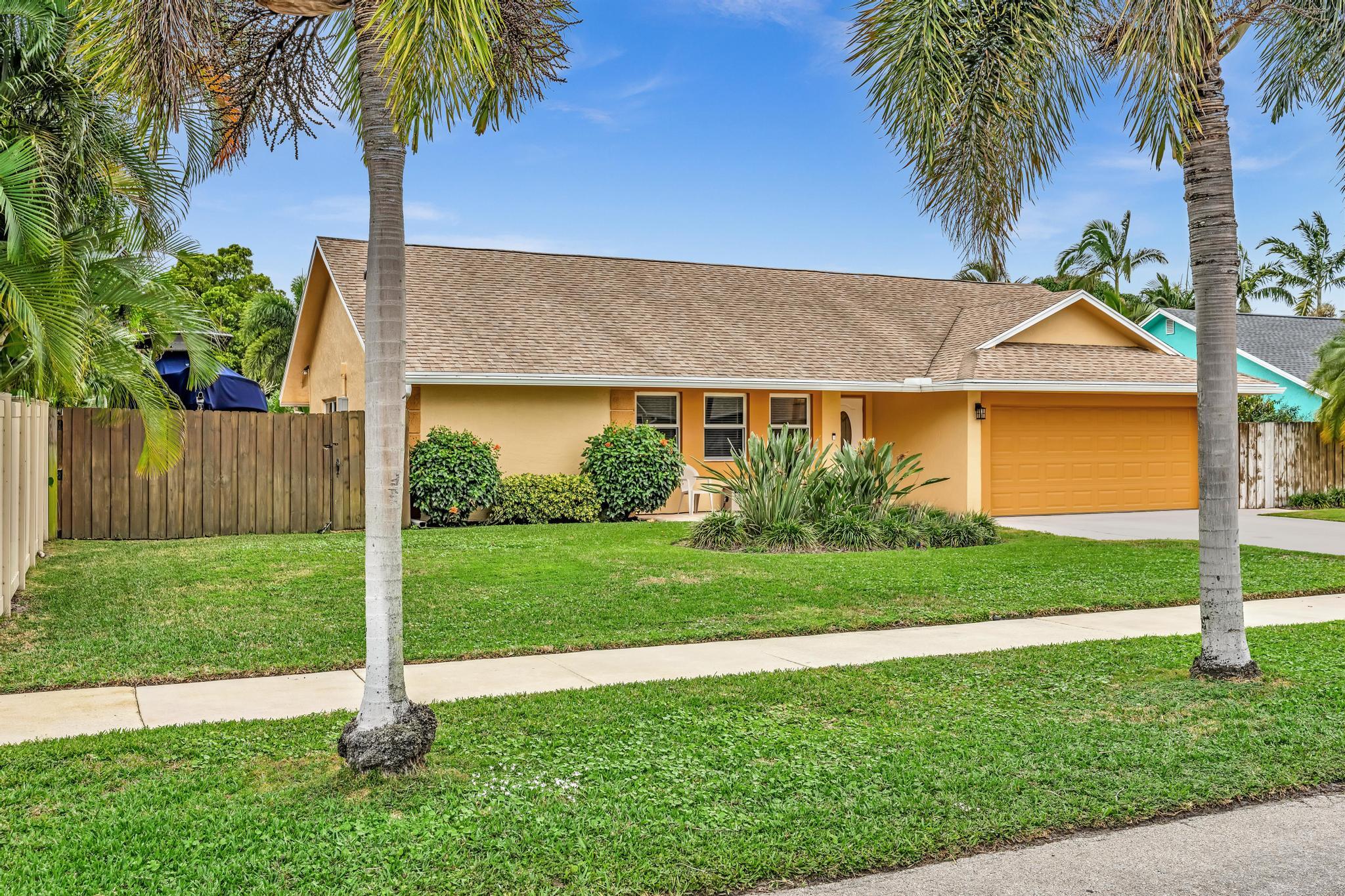 3106 Cormorant Road Delray Beach, FL 33444 - Photo 2 of 45 a view of a backyard with a plants and palm trees