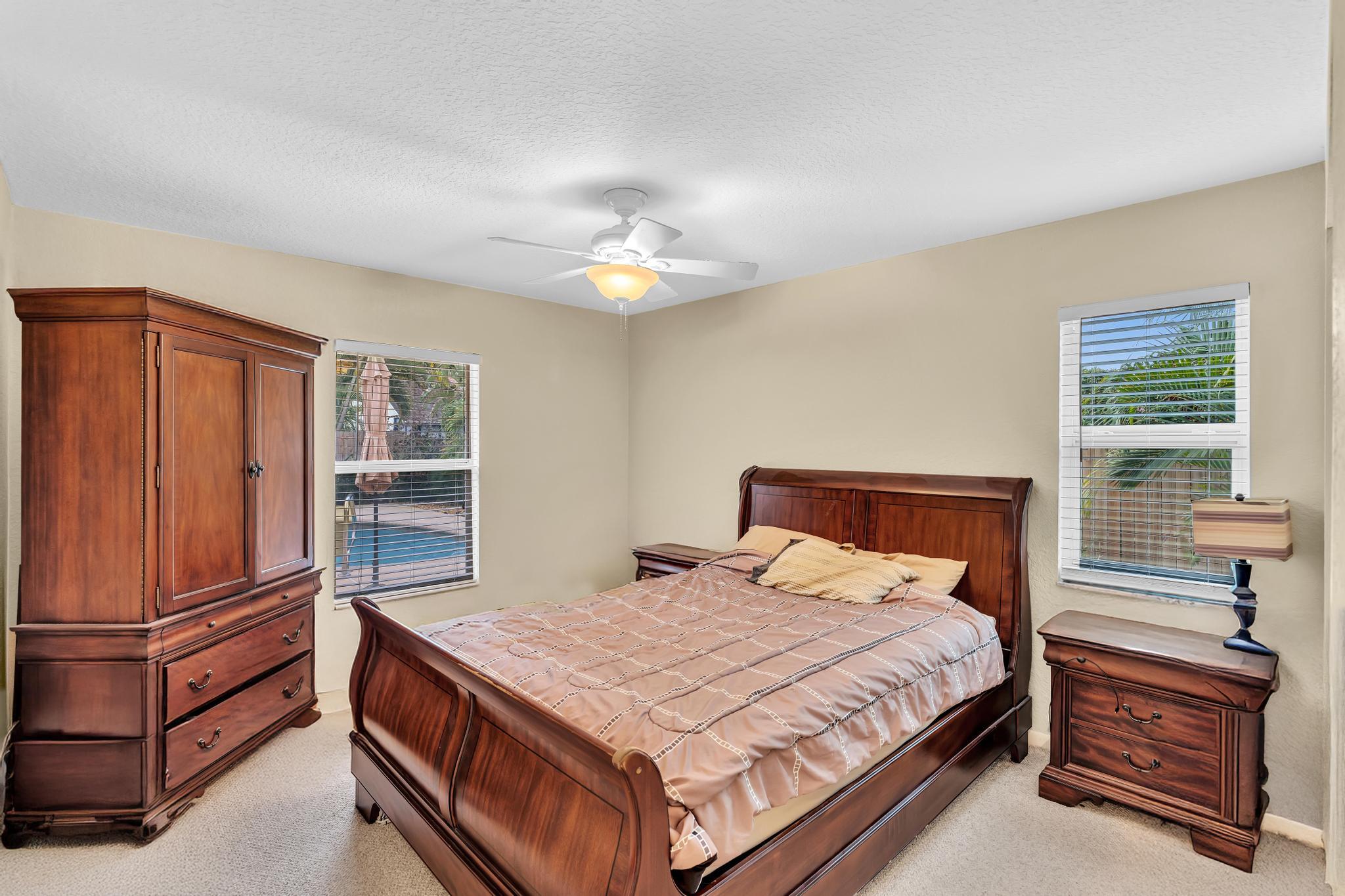 3106 Cormorant Road Delray Beach, FL 33444 - Photo 21 of 45 a bedroom with a bed and a dresser