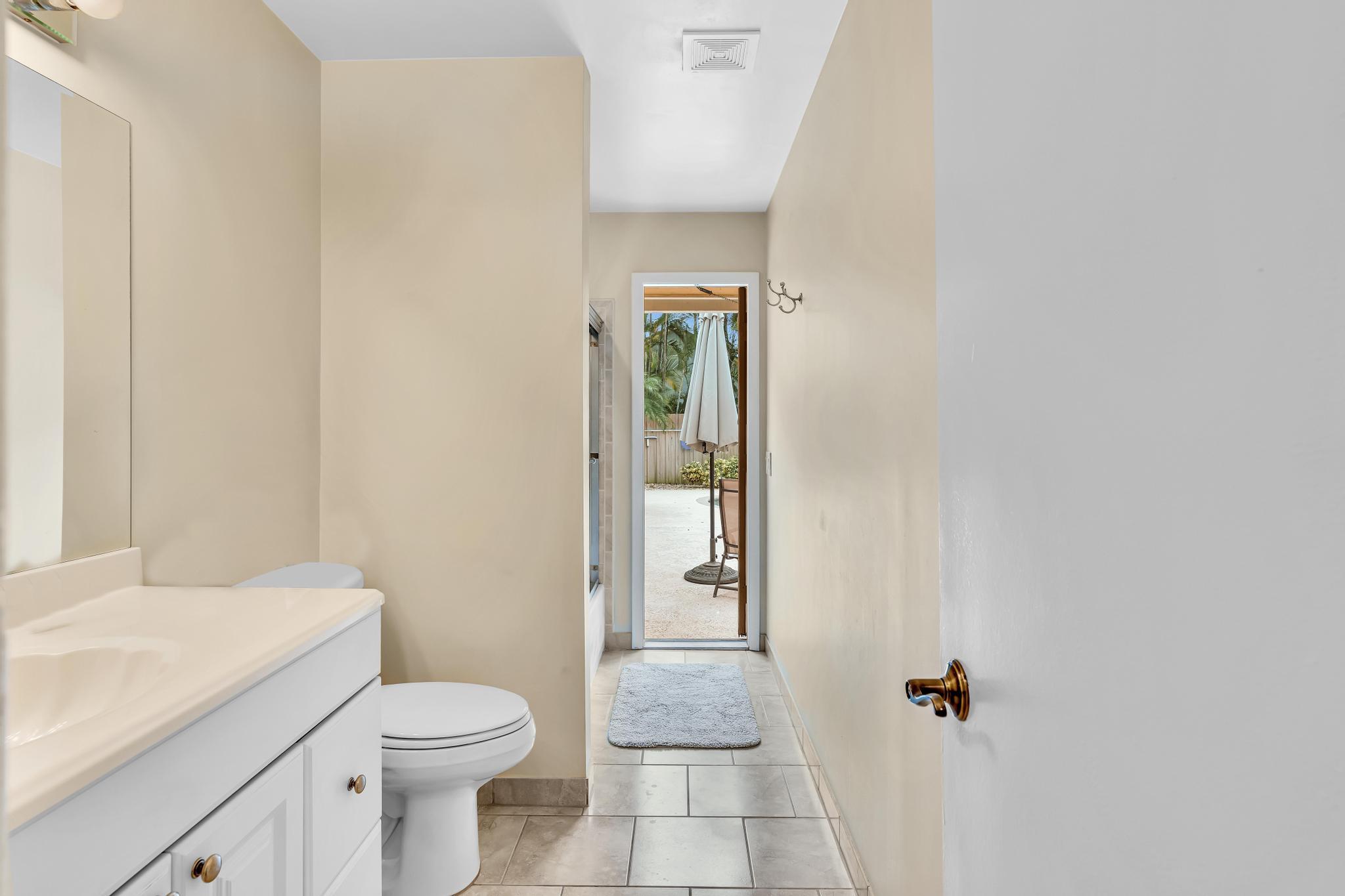 3106 Cormorant Road Delray Beach, FL 33444 - Photo 24 of 45 a bathroom with a granite countertop toilet and a sink