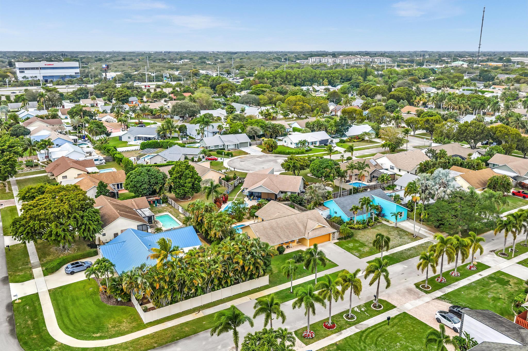 3106 Cormorant Road Delray Beach, FL 33444 - Photo 33 of 45 an aerial view of residential houses with outdoor space and trees