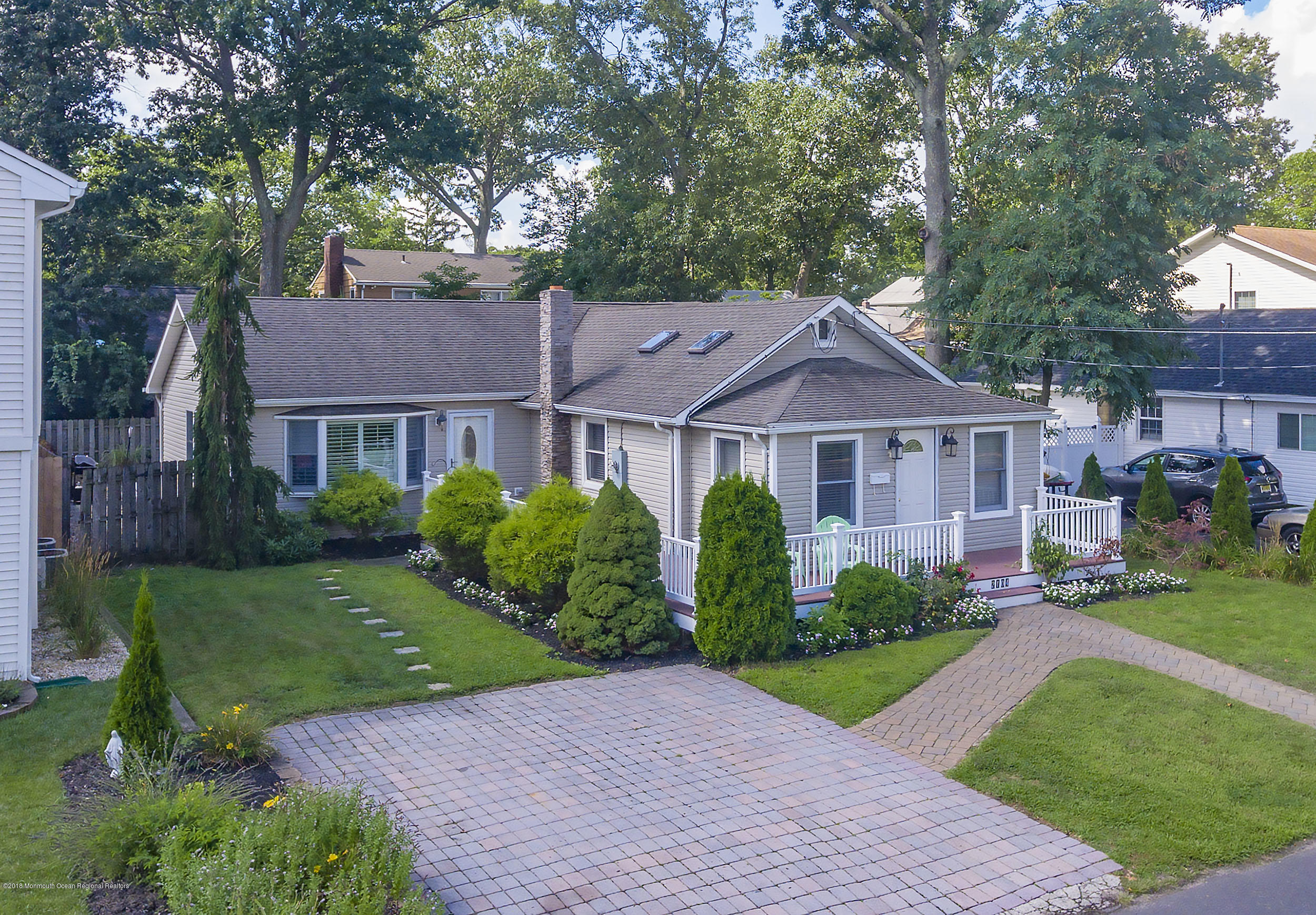 a front view of a house with yard and green space
