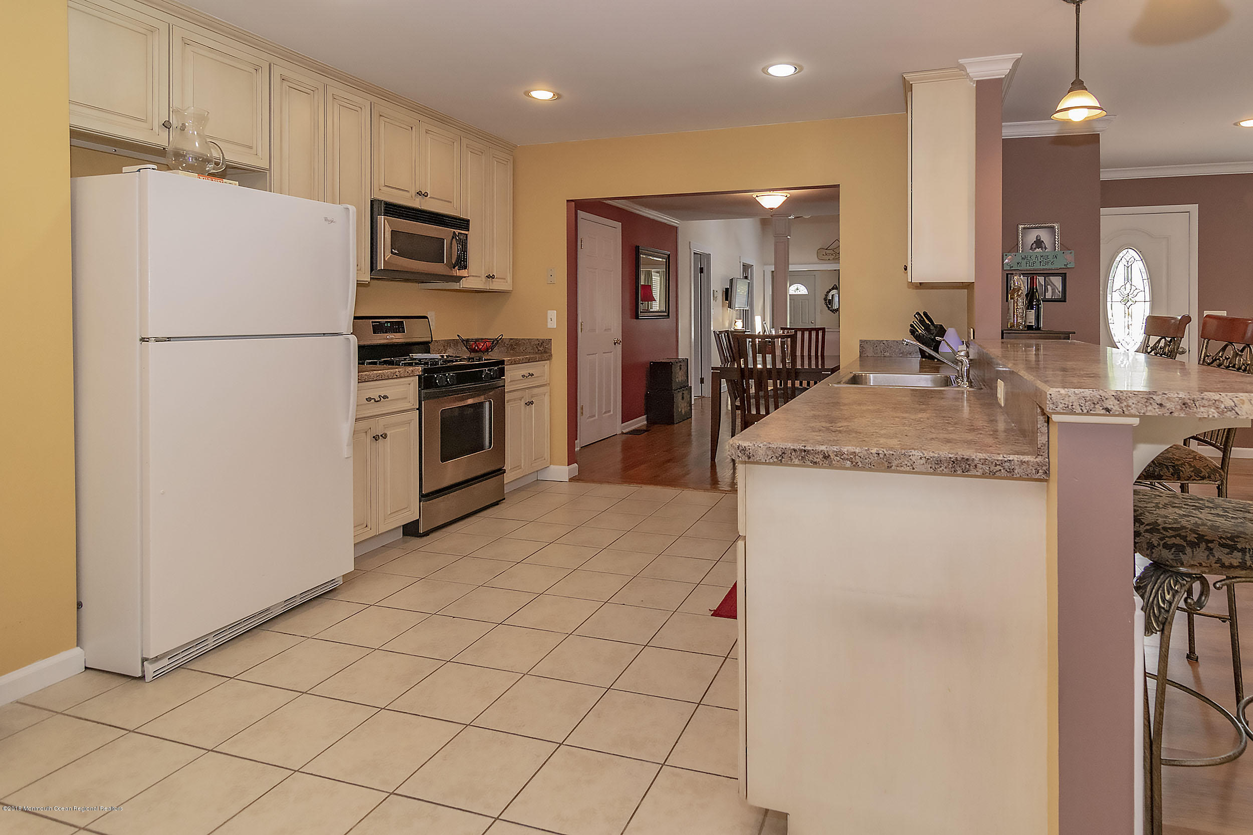 2104 River Road Point Pleasant, NJ 08742 - Photo 11 of 35 a kitchen with kitchen island a counter top space a sink stainless steel appliances and cabinets