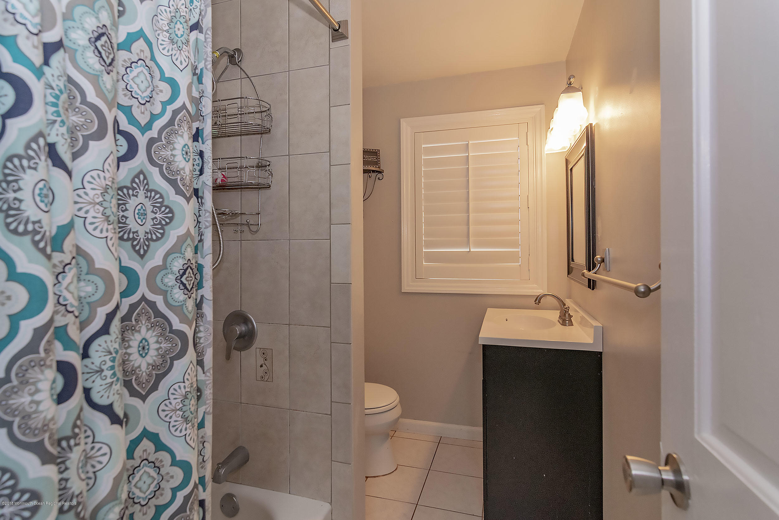 2104 River Road Point Pleasant, NJ 08742 - Photo 20 of 35 a bathroom with a granite countertop sink a toilet and shower