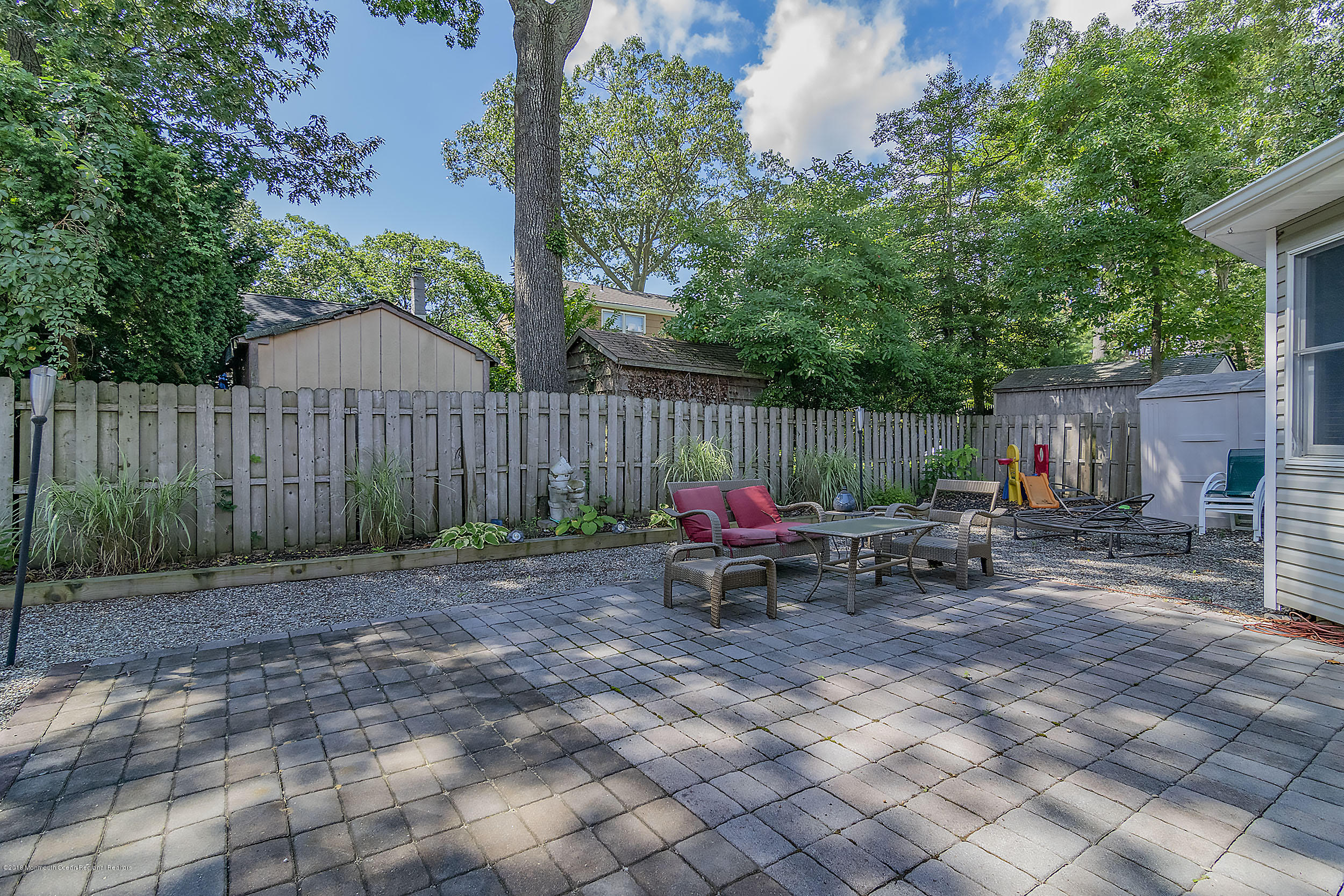 2104 River Road Point Pleasant, NJ 08742 - Photo 24 of 35 a view of backyard with wooden fence and a bench