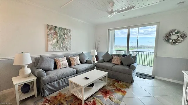 a living room with furniture a lamp and a window