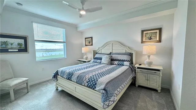 a bedroom with a bed lamp and a window