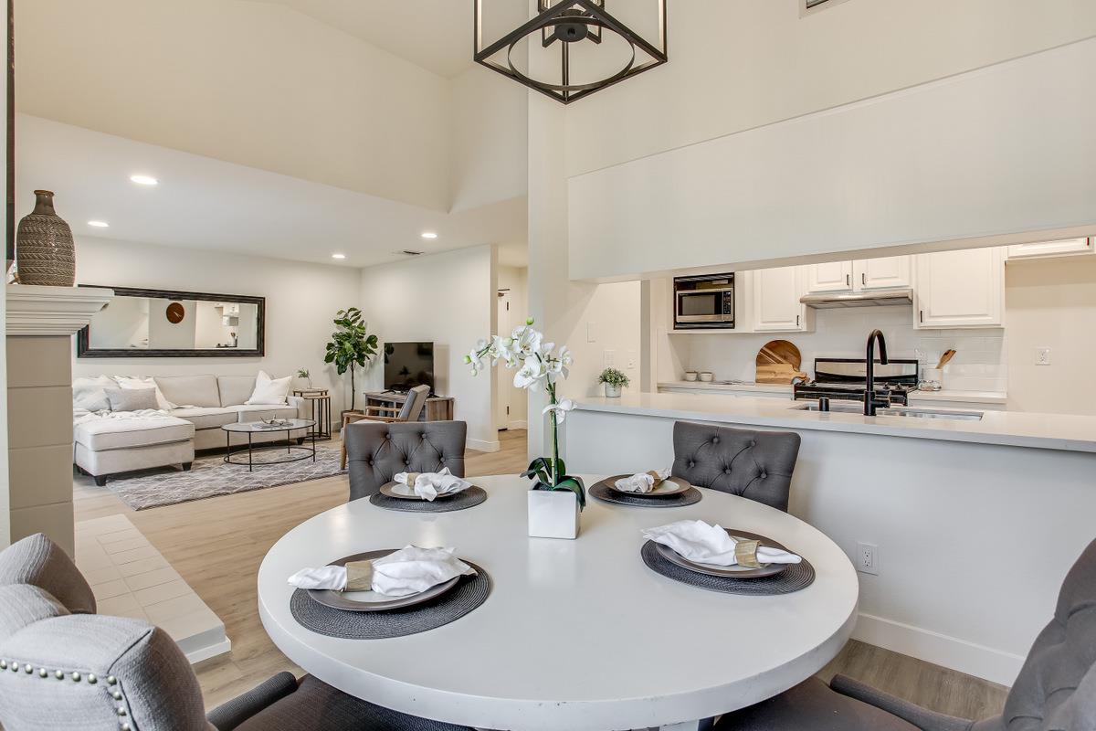 3705 Terstena Place, Unit 201 Santa Clara, CA 95051 - Photo 8 of 25 a kitchen with stainless steel appliances kitchen island granite countertop a table and chairs in it