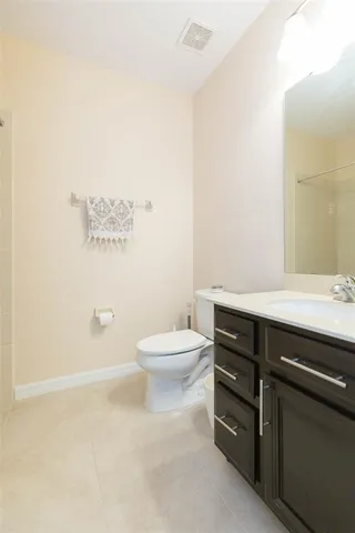 a kitchen with granite countertop a sink a stove and a wooden floors