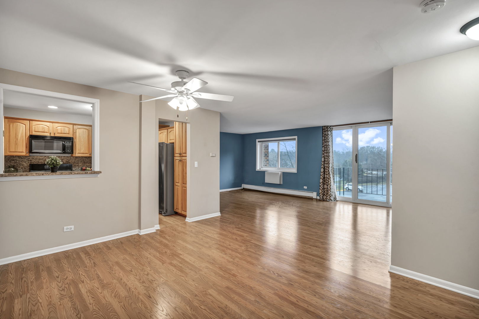 4721 St Joseph Creek Road, Unit 3H Lisle, IL 60532 - Photo 3 of 17 a view of an empty room with window and wooden floor
