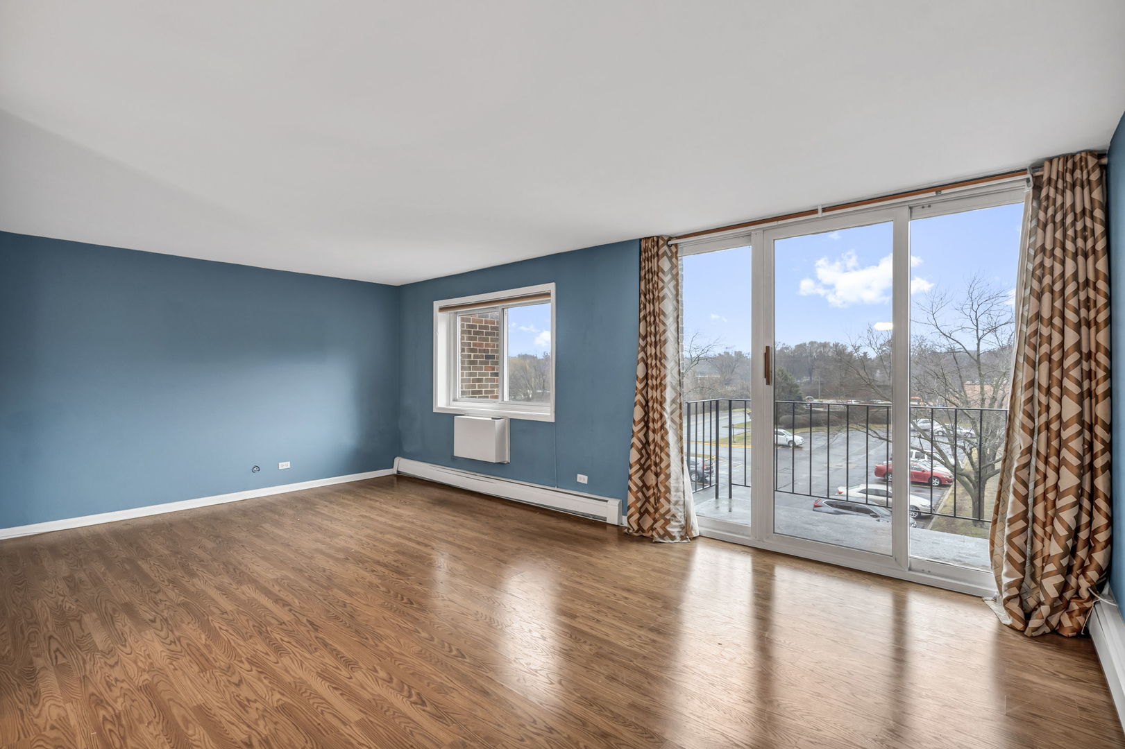 4721 St Joseph Creek Road, Unit 3H Lisle, IL 60532 - Photo 6 of 17 an empty room with wooden floor and windows
