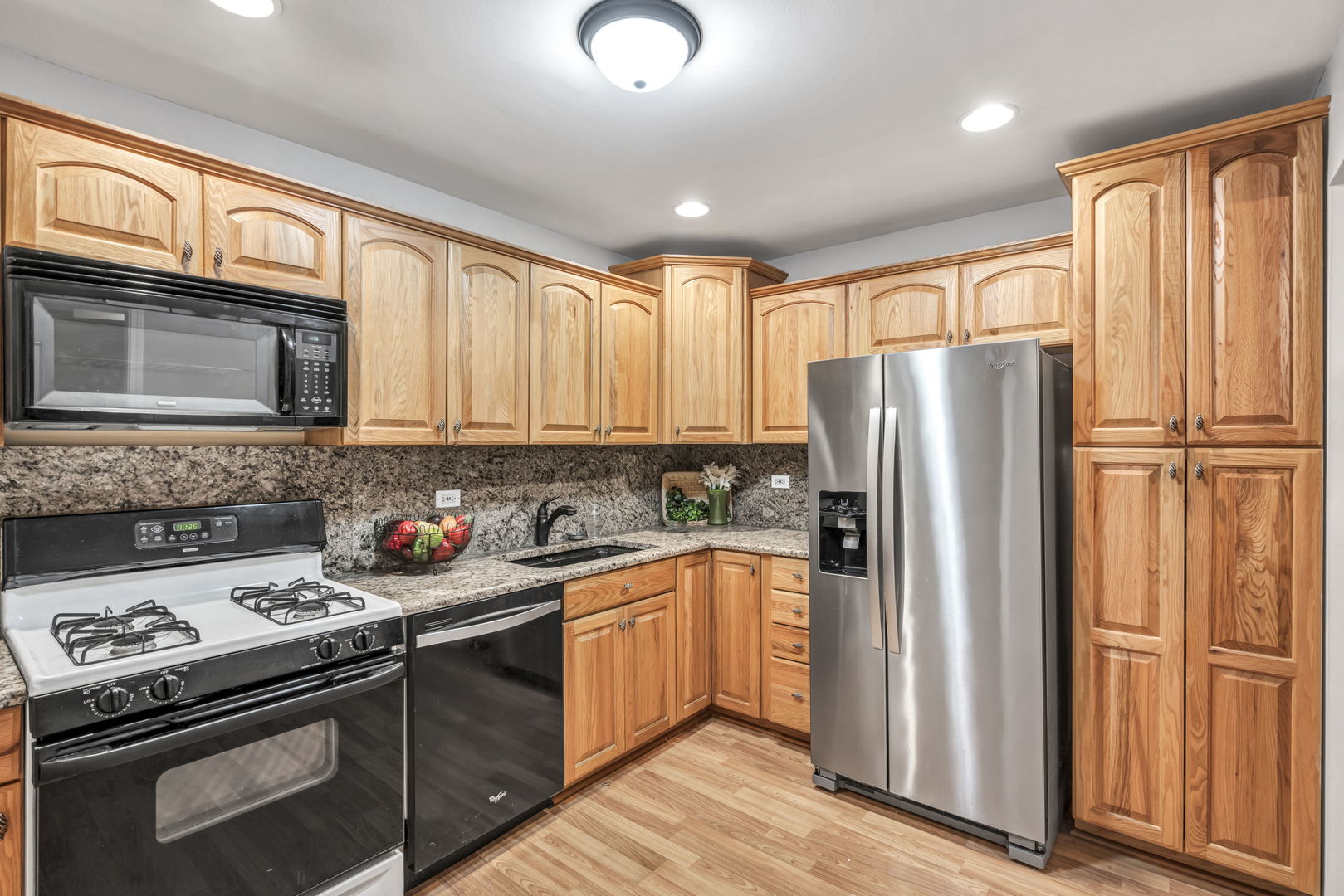 4721 St Joseph Creek Road, Unit 3H Lisle, IL 60532 - Photo 8 of 17 a kitchen with stainless steel appliances granite countertop a refrigerator stove and sink