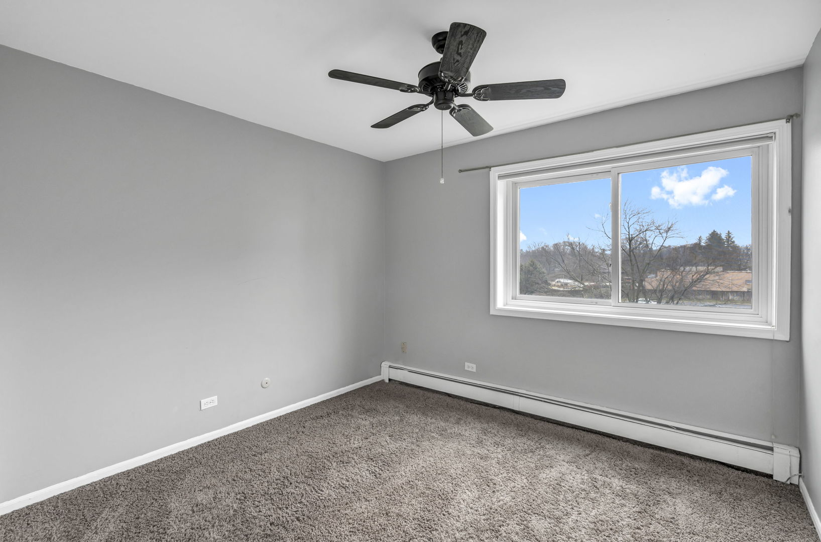 4721 St Joseph Creek Road, Unit 3H Lisle, IL 60532 - Photo 10 of 17 a view of a livingroom with a ceiling fan & a window
