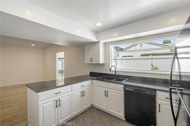 a kitchen with a sink cabinets and window