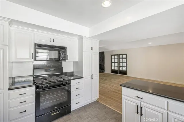a kitchen with granite countertop a stove and a sink