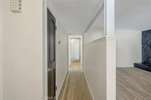 a view of a bedroom with wooden floor