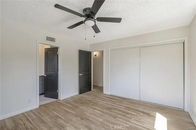 a view of a livingroom with a ceiling fan and wooden floor