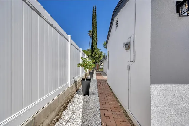 a view of a hallway with wooden floor and stairs